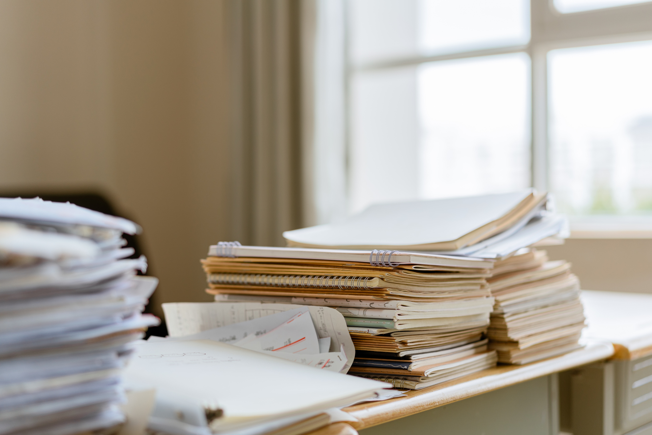 A stack of workbooks on the table